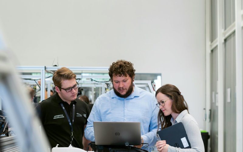 Team of engineers collaborating on a project in a modern industrial facility.